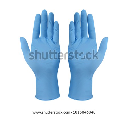 Medical nitrile gloves.Two blue surgical gloves isolated on white background with hands. Rubber glove manufacturing, human hand is wearing a latex glove. Doctor or nurse putting on protective gloves Royalty-Free Stock Photo #1815846848