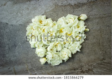 Styled stock photo. Feminine digital product mockup with rose flowers in form heart on shabby grey background. Flat lay, top view. Picture for blog or social media