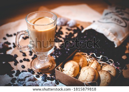 coffee composition with a glass of coffee and sweets on a rustic background close up
