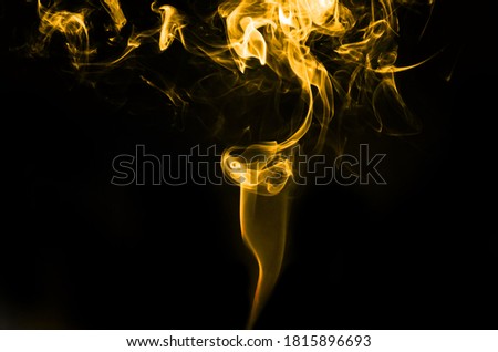 abstract fragment movement of gold yellow smoke on black background.