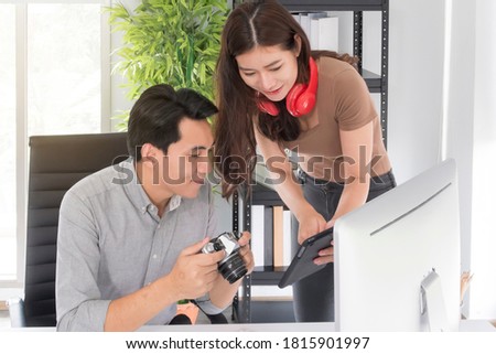 Portrait of Happy young couple Asian man and woman graphic designer discussing on projects while working together in the modern creative office. Business Creative people, Teamwork concept.
