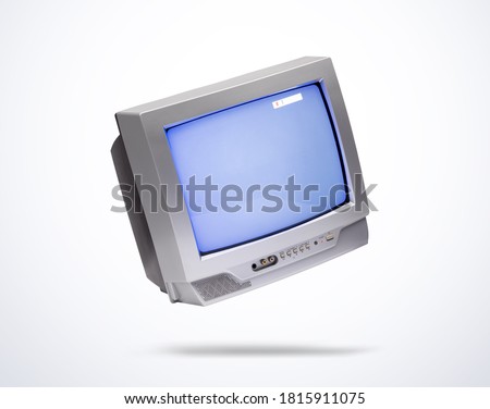 Working old gray CRT TV set in air, on light background. File contains a path to isolation. Royalty-Free Stock Photo #1815911075