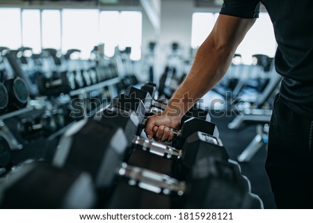 Couch at gym holding weight. Royalty-Free Stock Photo #1815928121