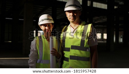 Portrait Asian Industrial Engineers In Hard Hat Wearing Safety Jacket Working In The Building Construction Site Together