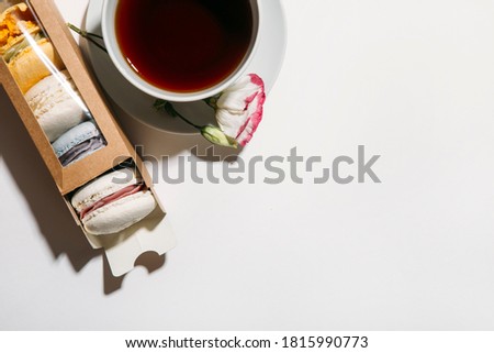 a Cup of coffee and macaroons on a white background. flat lay, top view 