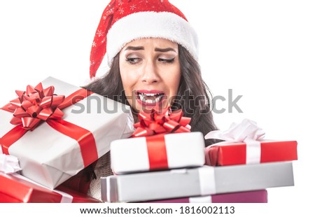 Female with a pile of Xmas presents in her hands falling down, desperate facial expression.