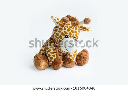 Plush toy giraffe isolated on a white background Colorful plush toy. Colored stuffed toy-giraffe. White and brown giraffe