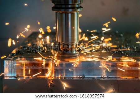 The burning chip from CNC milling machine rough cutting  by index-able  end-mill tools. The index-able tool wear from machining center. Royalty-Free Stock Photo #1816057574