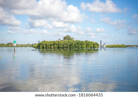 Indian River Lagoon Jungle Trail tropical paradise boating sky clouds water swamp wetlands trees nature outdoor Vero Beach, Florida Royalty-Free Stock Photo #1816064435
