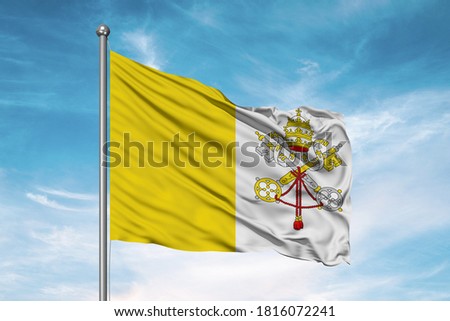 Vatican City national flag cloth fabric waving on beautiful sky.
