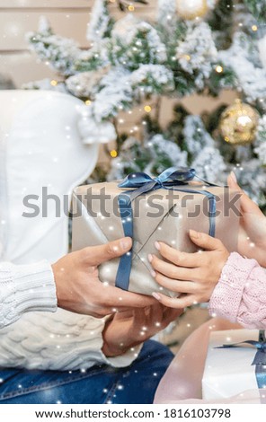 people with Christmas gifts in their hands. selective focus. happy.