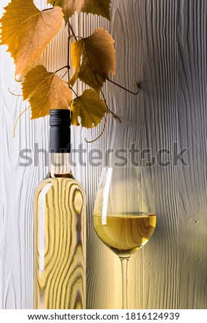 White wine and grapevine on a white wooden background. Copy space.