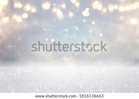 glitter vintage lights background. silver, gold and white. de-focused