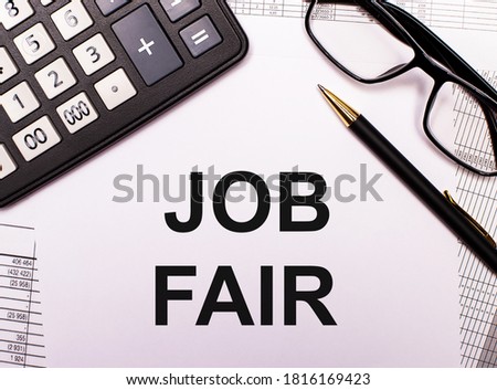 JOB FAIR written near a calculator, pen and glasses on a white background. Management concept