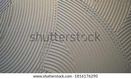 
cementitious adhesive applied to the floor ready to receive the ceramic tile Royalty-Free Stock Photo #1816176290