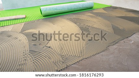 
cementitious adhesive applied to the floor ready to receive the ceramic tile Royalty-Free Stock Photo #1816176293