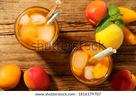 Delicious refreshing drink with apricot on wooden table, flat lay