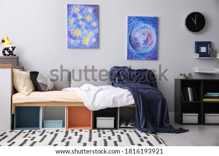 Modern teenager's room interior with comfortable bed and stylish design elements Royalty-Free Stock Photo #1816193921