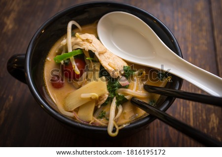 Hot and sour thai coconut curry soup with chicken