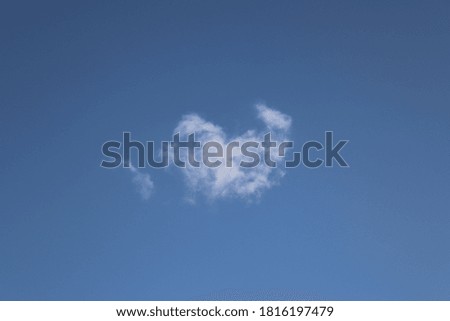 Fluffy white clouds in the bright blue sky