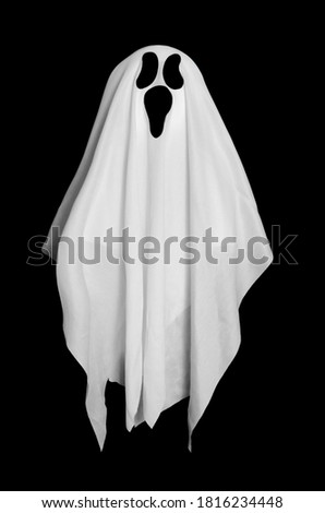 White ghost from the blanket on black background. Halloween decoration. 