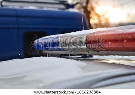 Close up of police car light flasher at sunset in winter. Selective focus. 