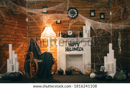 Cozy Halloween decorations with a fireplace and festive attributes. Photozone for Halloween. Background