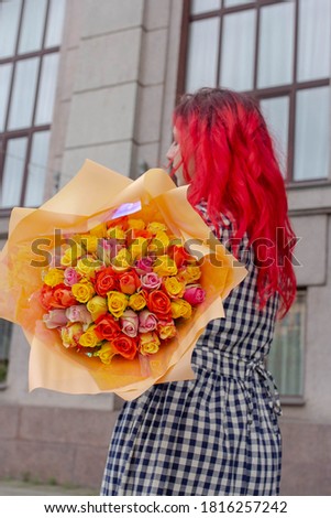 Girl with bouquet of roses, woman in plaid dress holding flowers, florist shop photo