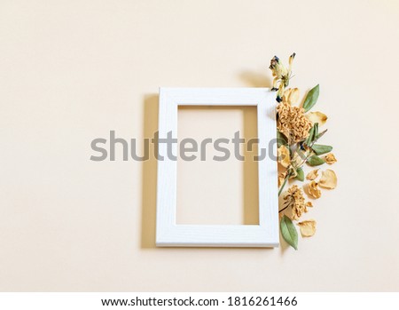 Square frame with dry lisiantum flowers on the gentle beige paper background. Flat lay, mock up photo, nice card design. 