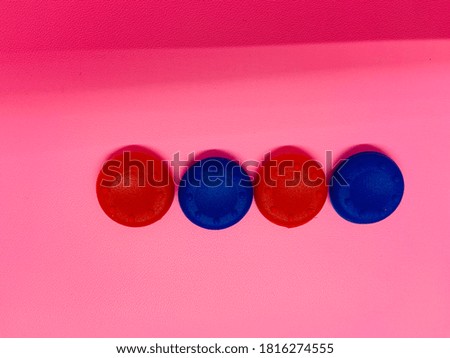 a colorful round object with a pink background
