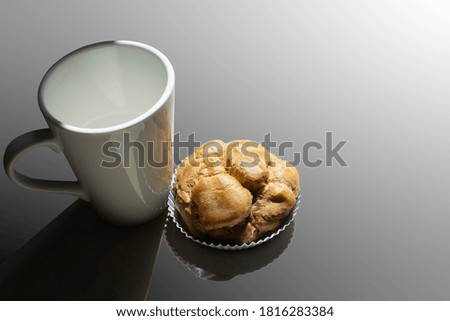 an empty cup tea or coffee with a snack 