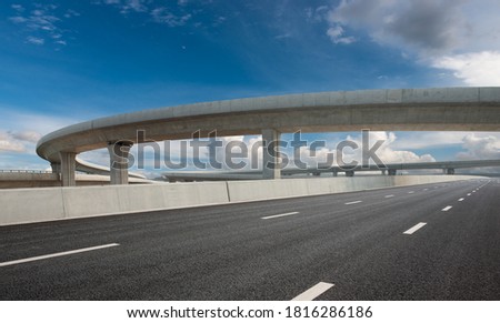 Clear sky, highway pavement under the overpass