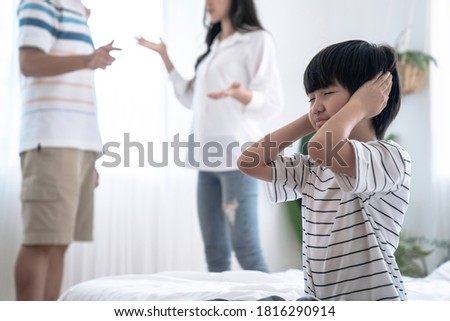 Crying illtle asian boy with his fighting parents in the background, Family problems, Divorce problem. Royalty-Free Stock Photo #1816290914