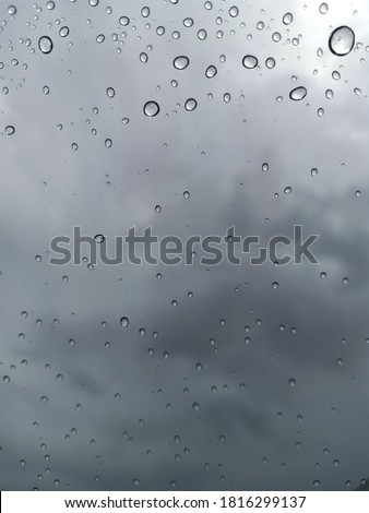 Look at the raindrops through the glass