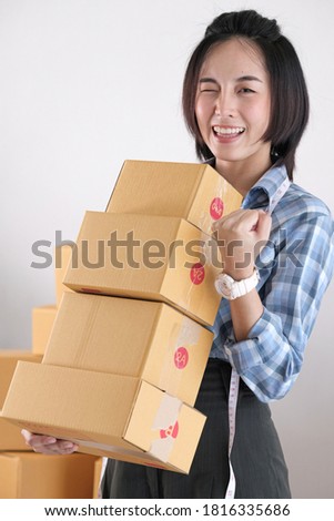 Young women hold parcel boxes, many idioms sold at online sellers against white walls.
