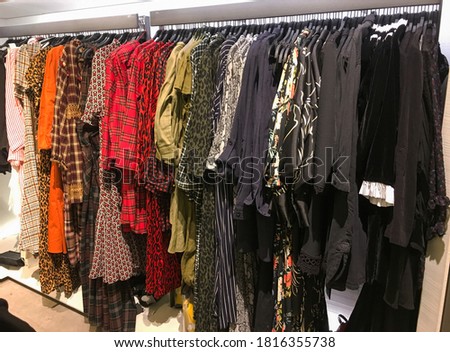Set of different colorful dress pants ,sundress,shirt on rack shopping. Cloth shop