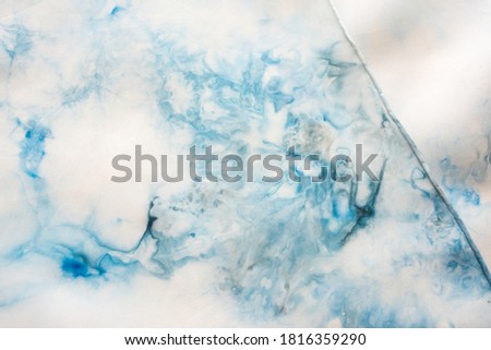 Close up of a blue pattern on silk texture - fashion background - studio shot from above 