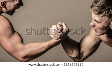 Rivalry, vs, challenge, strength comparison. Two men arm wrestling. Arms wrestling, competition. Rivalry concept - close up of male arm wrestling. Leadership concept.