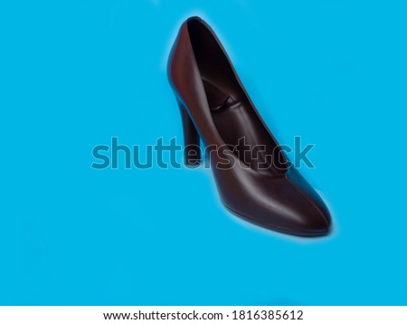 The shoes are made of dark chocolate on blue background
