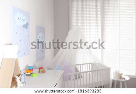 Baby room interior with cute posters and comfortable crib