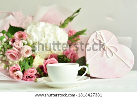 bouquet of delicate pink flowers and gift or present box . Flowers.Greeting card for Birthday, Woman or Mothers Day. I love you concept.Good morning.Selective focus.Copy space.