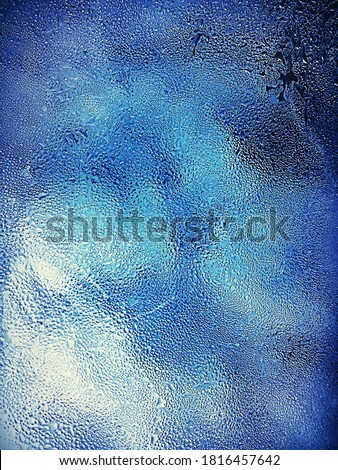 Misted Glass, beautiful icy blue water droplets condensation on winter cold glass window. Aquamarine wonders.