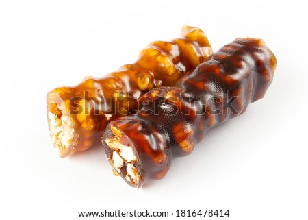Walnuts on a string dipped in starch grape molasses. Churchkhela. Walnut sujuk. Royalty-Free Stock Photo #1816478414