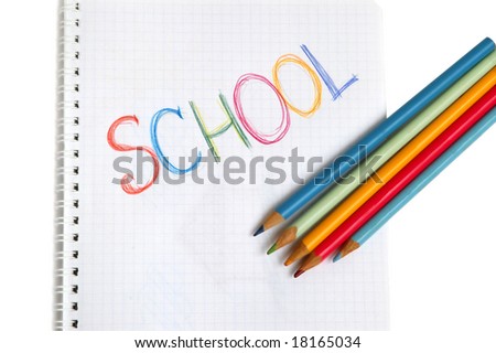 Child's drawing School in writing-book with color pencilse.