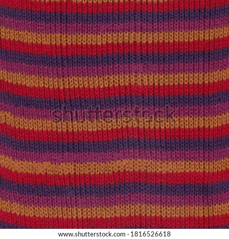 Part of a knitted shawl. Colors: orange, red, fuchsia, purple