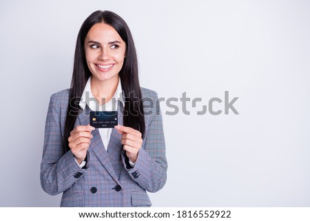 Photo of attractive business lady good mood plastic debit credit card advice new online transfer retail system service look interested empty space formalwear isolated grey color background