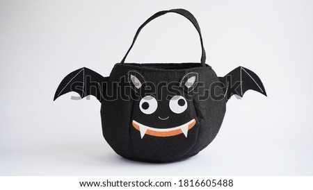 Black children's bag in the form of a bat for sweets on a white background, holiday of the dead, halloween.Trick or Treat Bag.