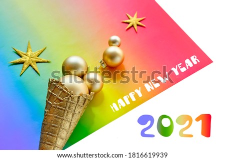 New Year 2021 greeting design in LGBTQ community. Ice cream cone, gold balls on rainbow paper, LGBT symbol.