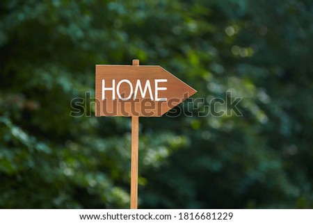 Wooden sign with the inscription Home. Real estate concept. Home sweet home.