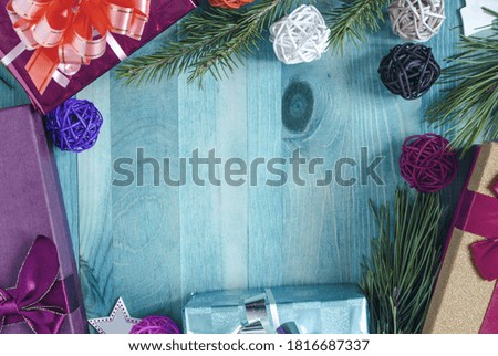 Christmas decorations colored gift boxes green fir branches on a wooden background copy the space top view	